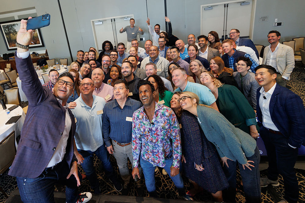 Photo of a large group of executives taking a selfie together
